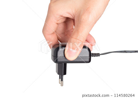 hand holding Power plug adapter 114580264