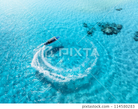 Aerial view of the speed boat in clear blue water in summer Aerial view of the speed boat in clear blue water in summer 114580283