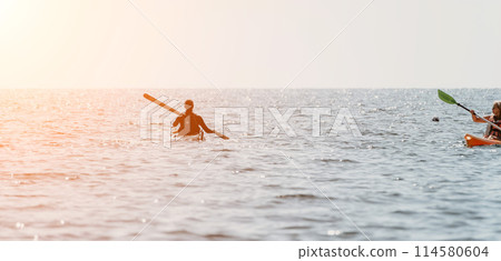 Woman sea kayak. Happy smiling woman in kayak on ocean, paddling with wooden oar. Calm sea water and horizon in background. Active lifestyle at sea. Summer vacation. 114580604