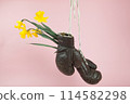 a pair of old boxing gloves hacked to become a vase 114582298