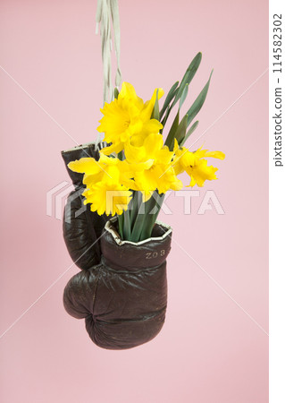 a pair of old boxing gloves hacked to become a vase 114582302