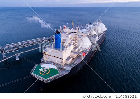 Aerial of Liquified Natural Gas LNG carrier moored to a small gas terminal. Fuel crisis. Sanctions Aerial of Liquified Natural Gas LNG carrier moored to a small gas terminal. Fuel crisis. Sanctions 114582521
