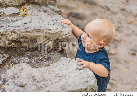 Baby tourist at Coba, Mexico. Ancient mayan city in Mexico. Coba is an archaeological area and a famous landmark of Yucatan Peninsula. Cloudy sky over a pyramid in Mexico Baby tourist at Coba, Mexico. Ancient mayan city in Mexico. Coba is an archaeological area and a famous landmark of Yucatan Peninsula. Cloudy sky over a pyramid in Mexico 114583135
