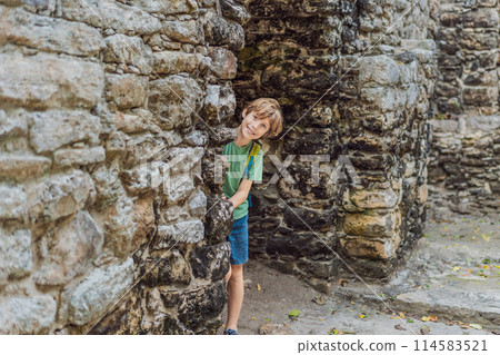 Boy tourist at Coba, Mexico. Ancient mayan city in Mexico. Coba is an archaeological area and a famous landmark of Yucatan Peninsula. Cloudy sky over a pyramid in Mexico 114583521