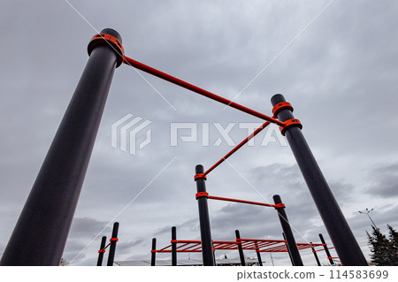 Modern sports field with horizontal bars in the park. Street workout. Modern sports field with horizontal bars in the park. Street workout. 114583699