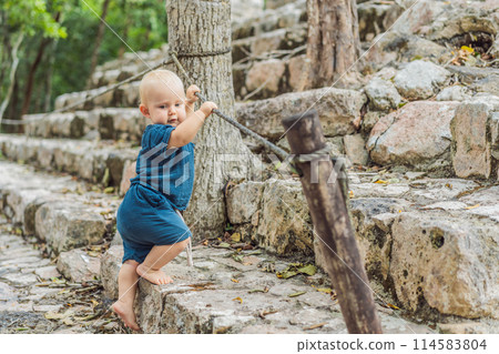 Baby tourist at Coba, Mexico. Ancient mayan city in Mexico. Coba is an archaeological area and a famous landmark of Yucatan Peninsula. Cloudy sky over a pyramid in Mexico Baby tourist at Coba, Mexico. Ancient mayan city in Mexico. Coba is an archaeological area and a famous landmark of Yucatan Peninsula. Cloudy sky over a pyramid in Mexico 114583804