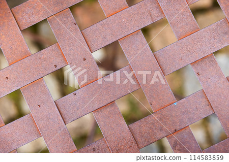 Abstract industrial photo. A grid of intertwined rusty metal strips Abstract industrial photo. A grid of intertwined rusty metal strips 114583859