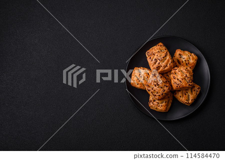Triangular puffs with feta cheese, tomatoes with salt, spices and herbs 114584470