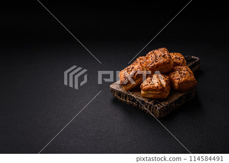 Triangular puffs with feta cheese, tomatoes with salt, spices and herbs 114584491