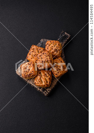 Triangular puffs with feta cheese, tomatoes with salt, spices and herbs 114584495