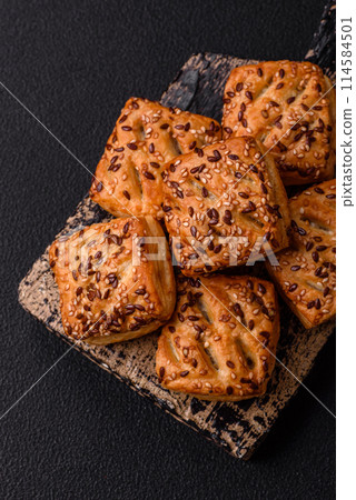 Triangular puffs with feta cheese, tomatoes with salt, spices and herbs Triangular puffs with feta cheese, tomatoes with salt, spices and herbs 114584501