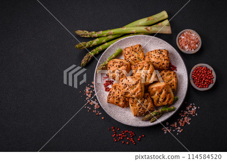 Triangular puffs with feta cheese, tomatoes with salt, spices and herbs Triangular puffs with feta cheese, tomatoes with salt, spices and herbs 114584520