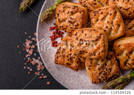 Triangular puffs with feta cheese, tomatoes with salt, spices and herbs Triangular puffs with feta cheese, tomatoes with salt, spices and herbs 114584526