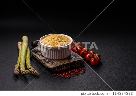 Raw stelline pasta from durum wheat with salt and spices Raw stelline pasta from durum wheat with salt and spices 114584558