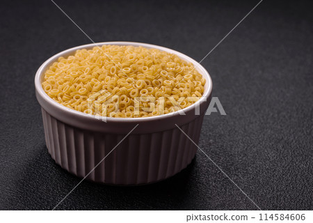 Raw anellini pasta from durum wheat with salt and spices Raw anellini pasta from durum wheat with salt and spices 114584606