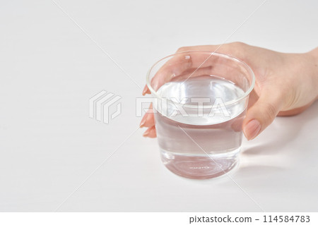 Women's hand with glasses with water Women's hand with glasses with water 114584783