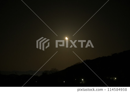 A waning quarter moon with a lunar age of 22.7 rising late at night in the month of Uzuki. 114584938