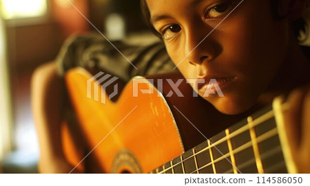 The close up picture of hispanic male playing guitar inside his own room. AIG43. 114586050