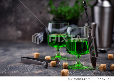 Glass of absinthe with cane sugar Glass of absinthe with cane sugar 114587032