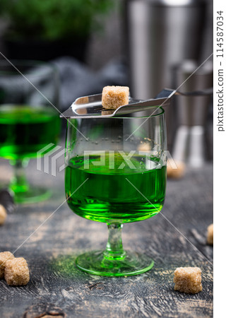 Glass of absinthe with cane sugar Glass of absinthe with cane sugar 114587034