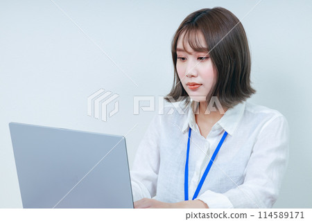 Young woman operating a PC close-up Young woman operating a PC close-up 114589171