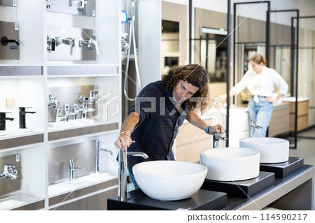 Man looking to buy new bathroom sink in harware store 114590217