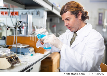 Portrait of an adult male using equipment to work in a laboratory Portrait of an adult male using equipment to work in a laboratory 114590597