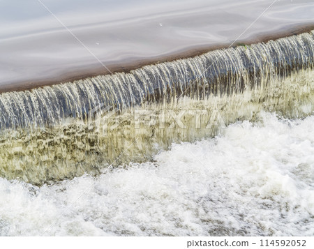 A small flat cascade in a calm river 114592052