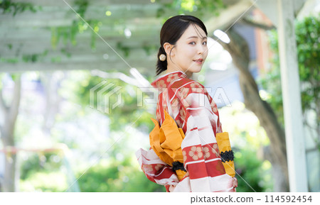 A woman wearing a yukata outdoors in the greenery, a beautiful woman looking back A woman wearing a yukata outdoors in the greenery, a beautiful woman looking back 114592454
