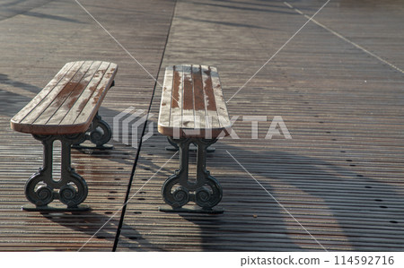 Romantic couple wooden benches made to wooden and iron stands on pedestrian bridge. 114592716