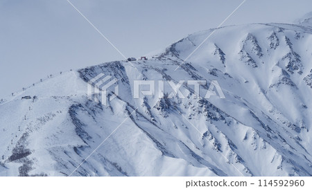 The Northern Alps in mid-winter covered in clouds, Hakuba Village, Nagano Prefecture 114592960