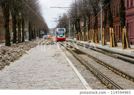 Street reconstruction, tree trunks with board protectors, newly replaced tram tracks and pavement 114594965