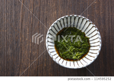 Mekabu (seaweed) served in a small bowl with sauce Mekabu (seaweed) served in a small bowl with sauce 114595252