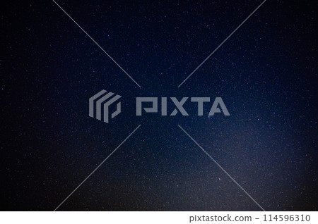 A quiet night view with a starry sky and mountain silhouettes 114596310