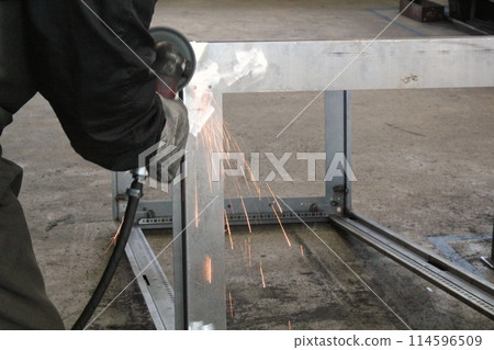 Heavy industry factory worker welding metal construction. Craftsman cutting steel production. Welder working in workshop. Master processing in plant. Industrial safety concept. 114596509