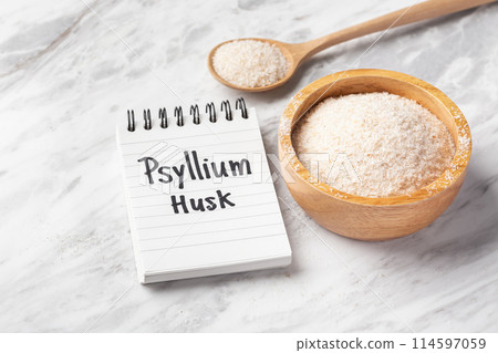 Psyllium husk in wood bowl and spoon with psyllium husk word on notebook on white marble table 114597059