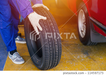 Wheel Tire change, Garage mechanic worker replace car tyre new rubber wheels in auto service workshop center 114597173
