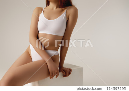 Cropped image of female body, breast in white 114597295