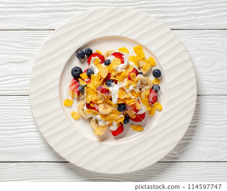 fresh berries, banana with corn flakes and yogurt fresh berries, banana with corn flakes and yogurt 114597747