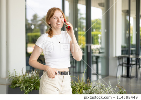 Happy blonde 30s woman talking phone and look happy outdoors Urban lifestyle concept. Summer time Happy blonde 30s woman talking phone and look happy outdoors Urban lifestyle concept. Summer time 114598449