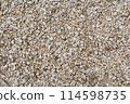 Close-up of small, multicolored gravel stones creating a rough, natural texture. 114598735