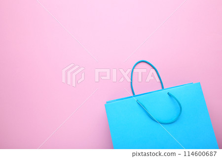 Blue paper shopping bag on pink background Blue paper shopping bag on pink background 114600687