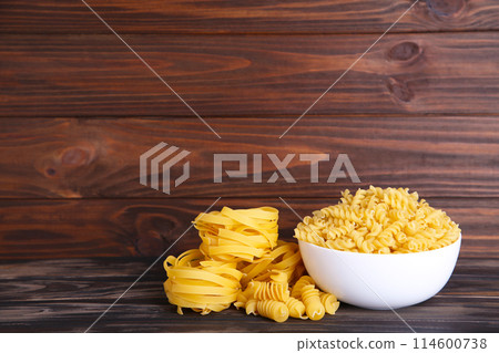 Delicious mixed pasta in bowl on a brown background 114600738