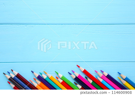 Many different colored pencils on blue wooden background Many different colored pencils on blue wooden background 114600908