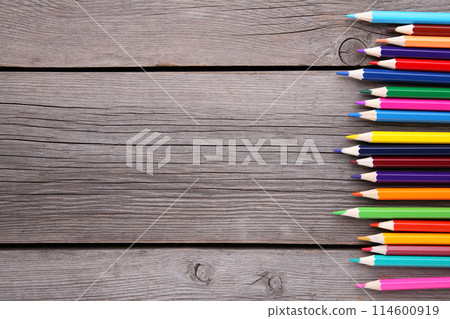 Many different colored pencils on grey wooden background Many different colored pencils on grey wooden background 114600919