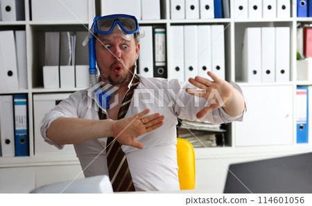 Man wearing suit and tie in goggles and snorkel 114601056