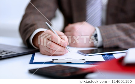 Male arm in suit and tie hold silver pen Male arm in suit and tie hold silver pen 114601190