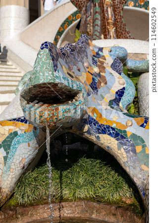 Multicolored mosaic of Salamander or Dragon. Lizard Fountain at Park Guell, popular touristic objects in Barcelona, Spain. Multicolored mosaic of Salamander or Dragon. Concept of tourism and vacation Multicolored mosaic of Salamander or Dragon. Lizard Fountain at Park Guell, popular touristic objects in Barcelona, Spain. Multicolored mosaic of Salamander or Dragon. Concept of tourism and vacation 114602549