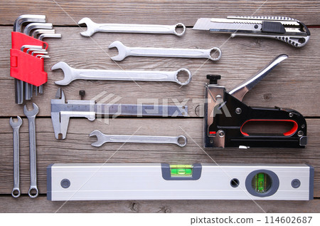 Construction tools on a grey wooden desk. Construction tools on a grey wooden desk. 114602687