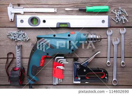 Construction tools on a grey wooden desk. Construction tools on a grey wooden desk. 114602690